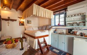 a small room with a bed and a kitchen at Theologos Houses in Grikos