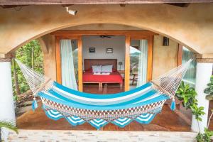 a hammock on the porch of a house at Casa Andalucia in San Juan del Sur