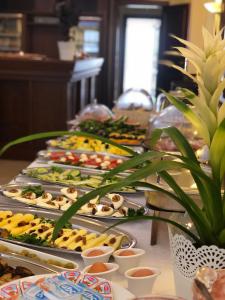 a buffet line with many plates of food on a table at Guest House Neho in Cres