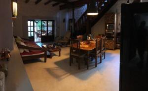 a living room with a table and chairs and a couch at La grange de G. in Grande Gaube