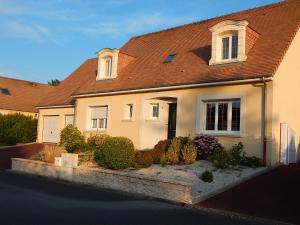 a white house with a brown roof at Audionnière in Saint-Gervais en-Belin