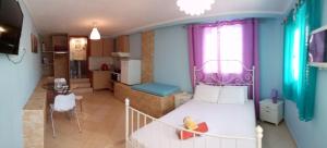 a small room with a bed and a kitchen at Villa Pavlina in Olympiada
