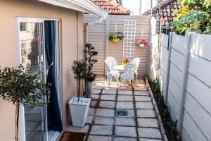 a small patio with two chairs and a table at The Studio on Balmoral in Durban