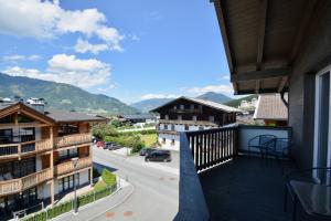 a balcony with a view of a street and mountains at Apartment Peter in Adler Resort by Z-K-H Rentals in Kaprun