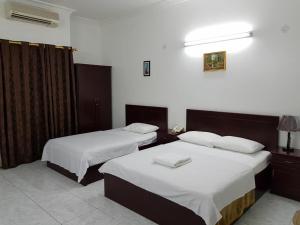 Ein Bett oder Betten in einem Zimmer der Unterkunft Sophin Hotel