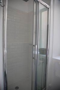 a shower with a glass door in a bathroom at L'authentique - Coeur de ville in Toulouse