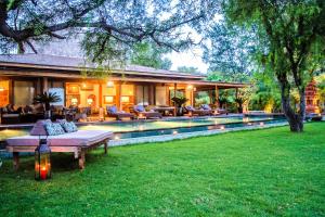 a house with a pool in the yard at Villa Pulau Cinta Boutique Suites in Gili Meno