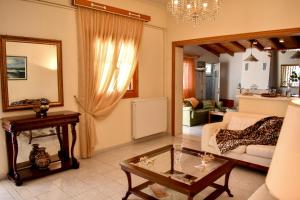 a living room with a couch and a table at Mayra Apartment in Lithakia +30 photos