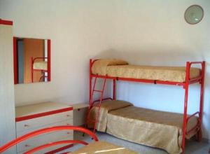 a room with two bunk beds and a mirror at Residence Oasi in Briatico