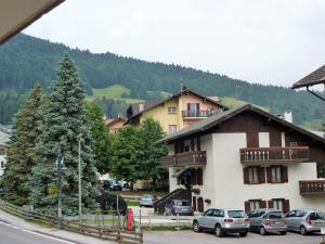 grupa samochodów zaparkowanych przed budynkiem w obiekcie Trentino Apartments - Casa ai Tolleri w mieście Folgaria