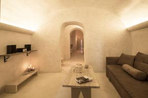 a living room with a couch and a table at The Dream Santorini in Oia