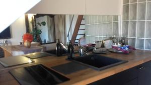 a kitchen counter with a sink and a mirror at ILE SAINT-LOUIS GLAMOROUS FLAT in Paris