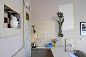 a kitchen with a white counter and a white cabinet at Villa Augustus in Dordrecht +33 photos