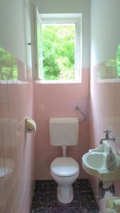 a pink bathroom with a toilet and a sink at Your Rooms in Portoroz TM in Portorož