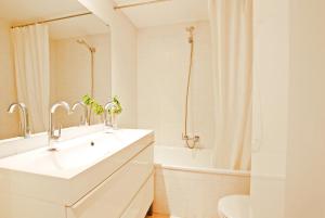 a white bathroom with a sink and a toilet at Blue fridge apartmen · Blue fridge apartmen · Ideal for couples, near beach and well connected in Vilassar de Mar +32 photos