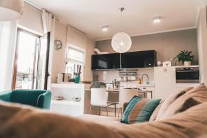 a living room with a couch and a kitchen at Apartment Serenum in Matulji