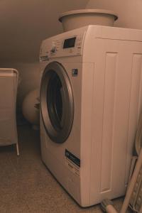 a washing machine is sitting in a room at Apartment Serenum in Matulji