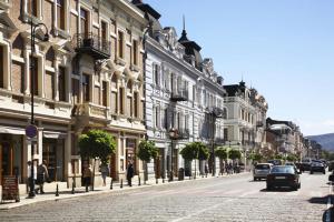 a city street with cars driving down a street with buildings at Bude Hostel in Tbilisi City