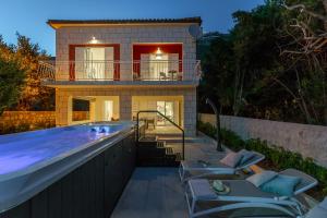 a villa with a swimming pool and a house at Hedera Estate, Villa Hedera V in Dubrovnik