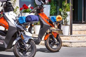 an orange motorcycle parked on the side of the street at Hotel Plaza in Pag