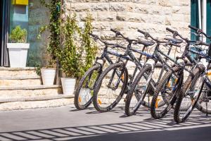 a row of bikes parked next to a building at Hotel Plaza in Pag