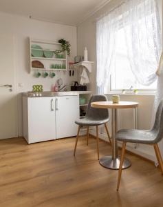 a kitchen with a table and two chairs in a room at Private and peaceful one bedroom apartments in Borgarnes
