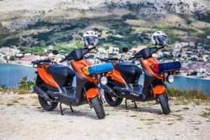 two motorcycles parked next to each other on a hill at Hotel Plaza in Pag