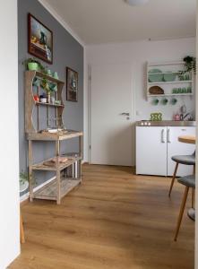 a living room with wooden floors and a kitchen at Private and peaceful one bedroom apartments in Borgarnes