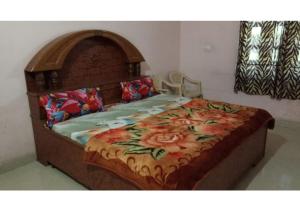 a large wooden bed with a blanket on it at Peaceful Palace in Pushkar in Pushkar