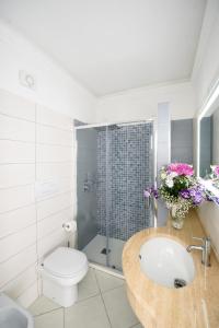 a bathroom with a sink and a toilet and a shower at Hotel Bussola in Anacapri