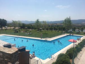 a large swimming pool with people in a park at Badaguas It's Cozy in Badaguás