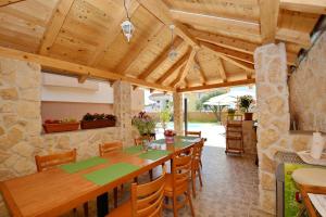 an open kitchen and dining room with a wooden ceiling at Villa Zupan in Zadar