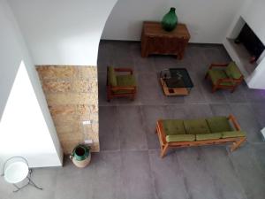 an overhead view of a living room with a couch and chairs at Cortile Calinea in Castrignano del Capo