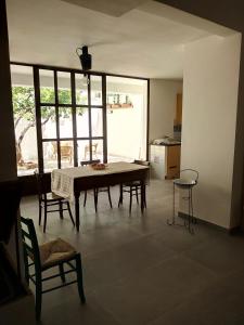 a dining room with a table and some chairs at Cortile Calinea in Castrignano del Capo
