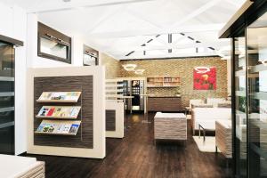 a store interior with a book shelf and tables at Bildungshaus St. Bernhard - Wohnen und Tagen in Rastatt