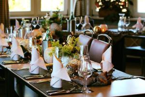 a long table with wine glasses and napkins on it at Landhotel Am Rothenberg in Uslar +131 photos