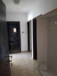 a room with a door and a hallway with a bathroom at Apartmani Vuksanović in Pag +20 photos