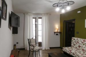 a living room with a couch and a chair at Arcipreste in Zamora