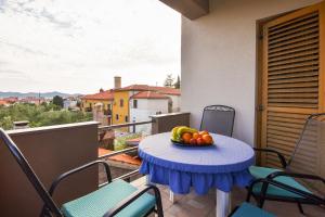 a bowl of fruit on a table on a balcony at Apartments Kostijal in Zadar