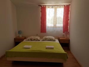 a bedroom with a bed with a green blanket and a window at Holiday Home Poljičko Imanje in Donji Dolac +74 photos