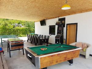 a pool table in a living room with a pool table at Holiday Home Poljičko Imanje in Donji Dolac