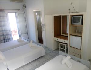 Postel nebo postele na pokoji v ubytování Hotel Faros