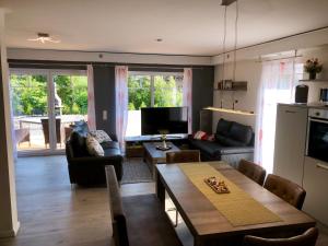 a living room with a couch and a table at Ferienhaus Traumspot in Wiek auf Rügen 