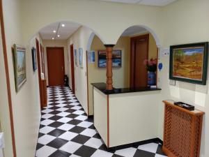 a hallway with a black and white checkered floor at Casa Mariñan in Sanxenxo