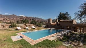 a swimming pool in the yard of a house at Posada de Luz in Tilcara