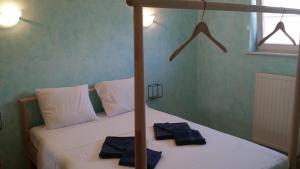 a bedroom with two beds with white sheets and blue towels at Villa Storme in Koksijde