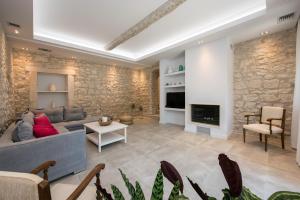 a living room with a couch and a fireplace at Villa Aelia in Kassiopi