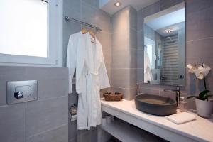 a bathroom with a sink and a mirror at Villa Aelia in Kassiopi +34 photos