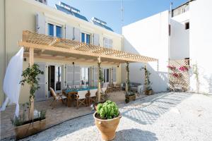 a patio with a wooden pergola and a table at Villa Aelia in Kassiopi