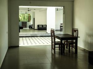 a dining room table and chairs in a living room at Opal Mirissa in Mirissa